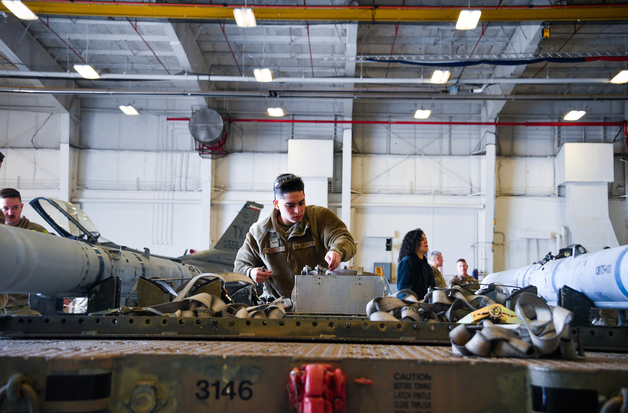 Senior Airman Vincent McGrath, 301st Fighter Wing Aircraft Maintenance Squadron load crew member, looks for tools at Naval Air Station Joint Base Fort Worth, Texas, January 9, 2022. The 301 FW annual weapons competition gives Airmen an opportunity to practice their technical skills in a controlled environment.
