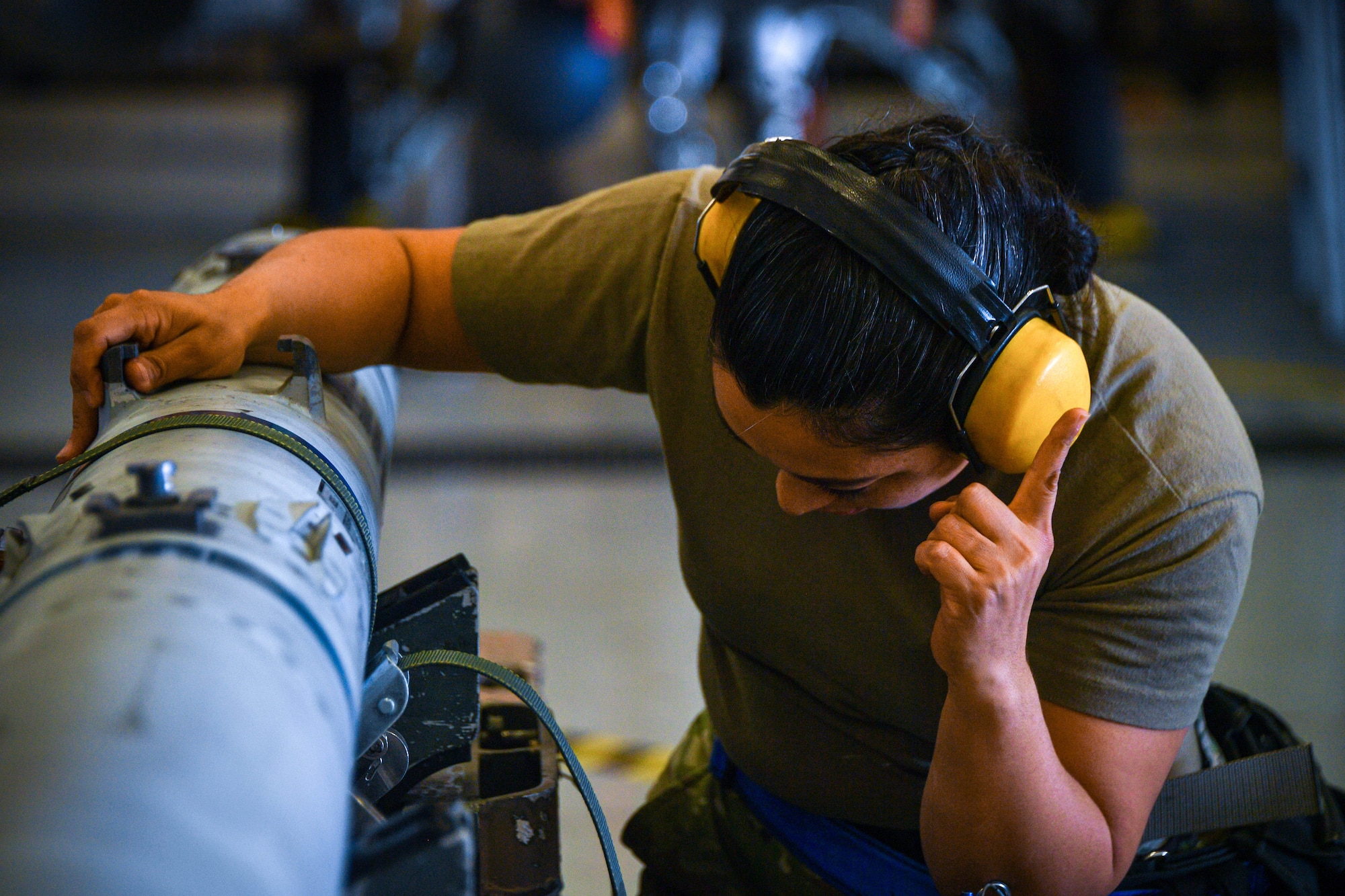 Staff Sgt. Kristen Semones, 43rd Fighter Generation Squadron, directs a AIM-120 missile’s movement during the unit’s weapons load competition at Naval Air Station Joint Reserve Base Fort Worth, Texas, Jan. 9, 2022. Four weapons load crews competed to see who could load a GBU-12 onto their aircraft the fastest and with the fewest errors. The winner will be announced in Feb.(U.S. Air Force photo by Staff Sgt. Nije Hightower)