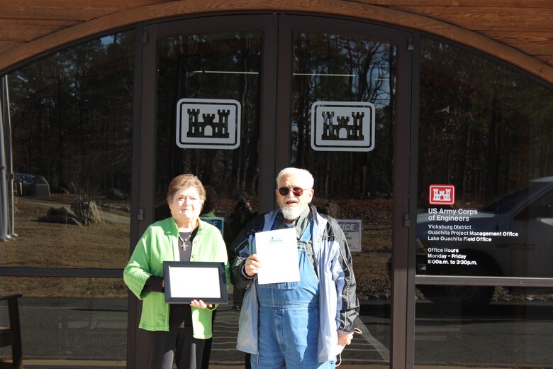 Two people in front of a building