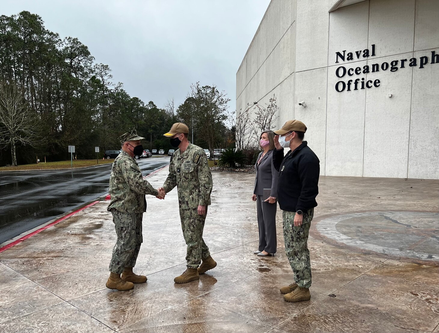 STENNIS, Miss. (Jan. 20, 2022) - Chief of Naval Operations (CNO) Adm. Mike Gilday is greeted by RDML Ron Piret, Commander, U.S. Naval Meteorology and Oceanography Command (CNMOC), CNMOC Command Master Chief Jessica Mihailin and Ms. Jennifer Hailes, CNMOC Technical Director (acting), during his visit to Stennis Space Center, Jan. 20, 2022. The Naval Meteorology and Oceanography Command directs and oversees more than 2,500 globally-distributed military and civilian personnel who collect, process and exploit environmental information to assist Fleet and Joint Commanders in all warfare areas to make better decisions faster than the adversary. (U.S. Navy photo by Lt. Bobby Dixon/released)