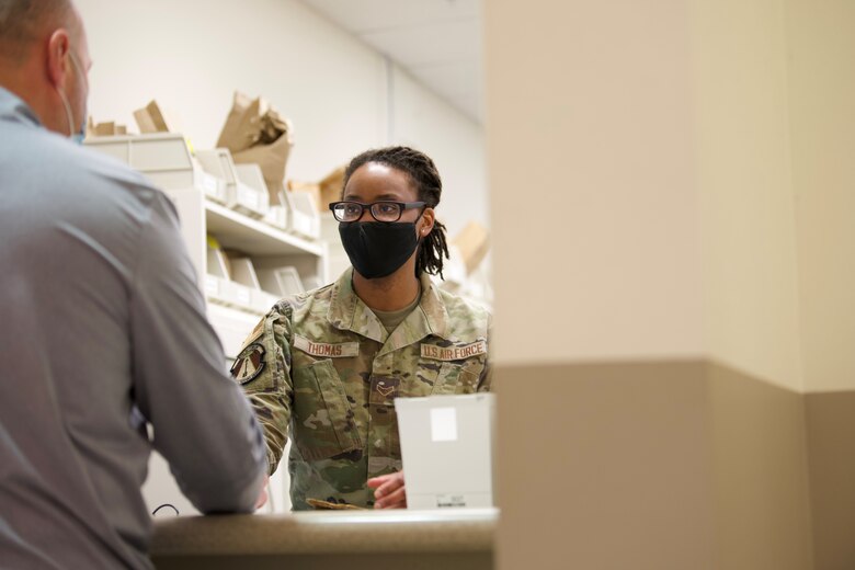 U.S. Air Force Airman 1st Class Victoria Thomas, 21st Medical Group medical logistics technician, helps a customer at the Satellite Pharmacy located inside of the Peterson Base Exchange on Peterson Space Force Base, Colorado, Jan. 12, 2022. The pharmacies on PSFB provide over 18,500 personnel and 173,000 local beneficiaries with quality medications, Monday through Friday from 7:30 a.m. to 4 p.m. (U.S. Space Force Photo by Airman 1st Class Ryan Prince)