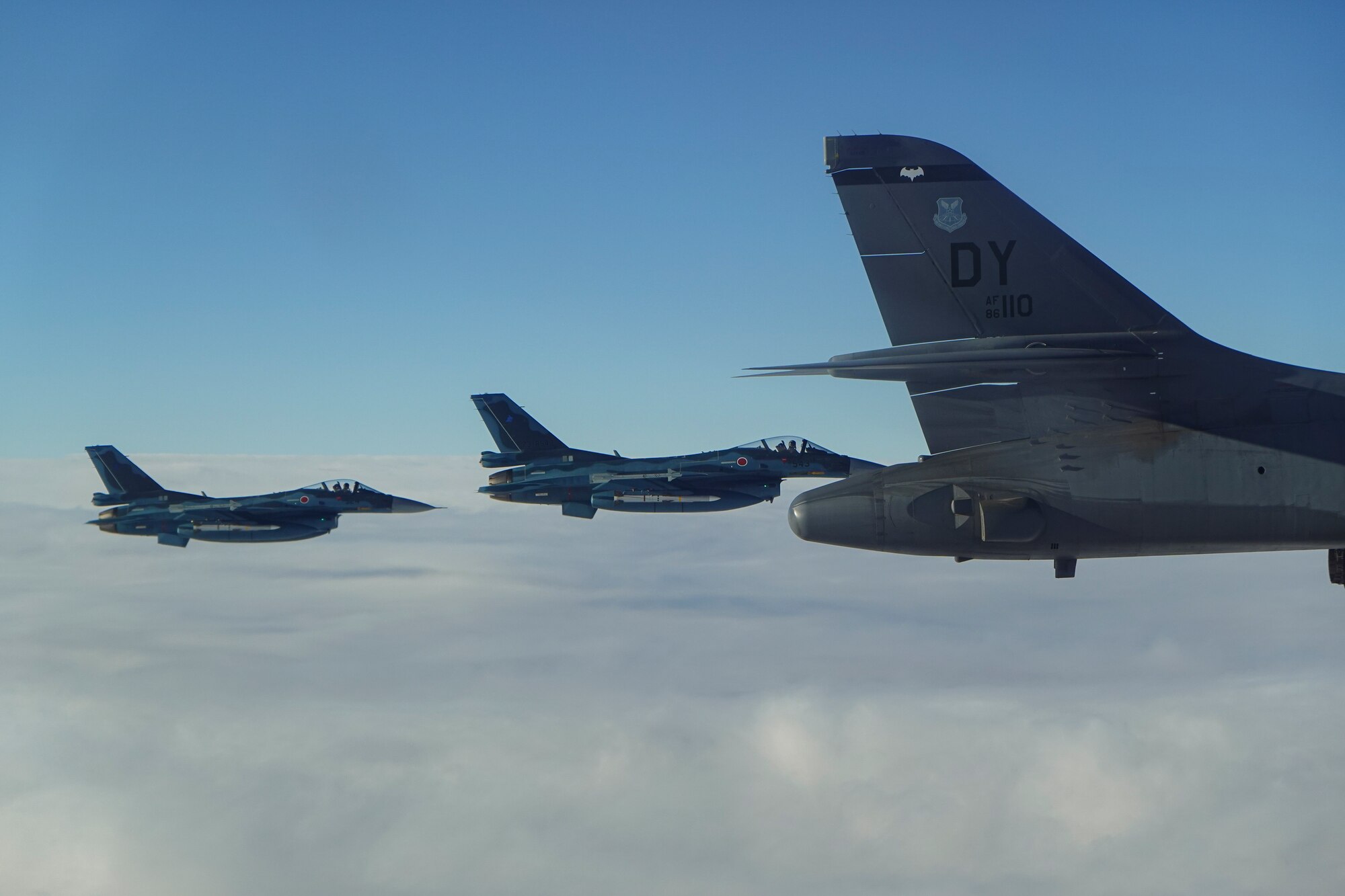 A B-1B Lancer from Dyess Air Force Base flies alongside two Japanese Air Self Defense Force F-16 Fighting Falcon aircraft during a joint Large Force Exercise in the Indo-Pacific region, Jan. 11, 2022. Conducting training missions alongside partners strengthens the joint force tactics within the Pacific region. (U.S. Air Force courtesy photo)