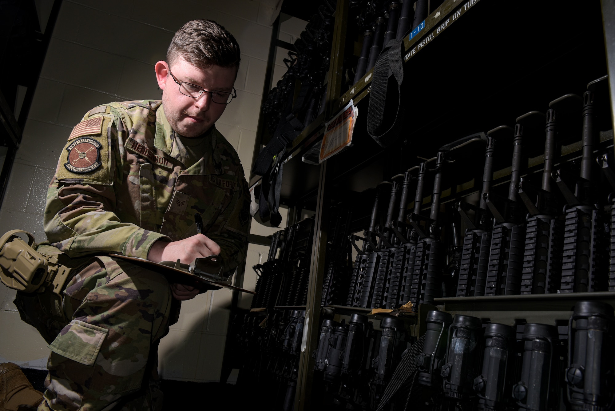 U.S. Air Force Senior Airman Robert Henderson, a 6th Logistics Readiness Squadron Individual Protective Equipment (IPE) technician, takes inventory of a M-16 assault rifle weapons rack at MacDill Air Force Base, Florida, Jan. 18, 2022.