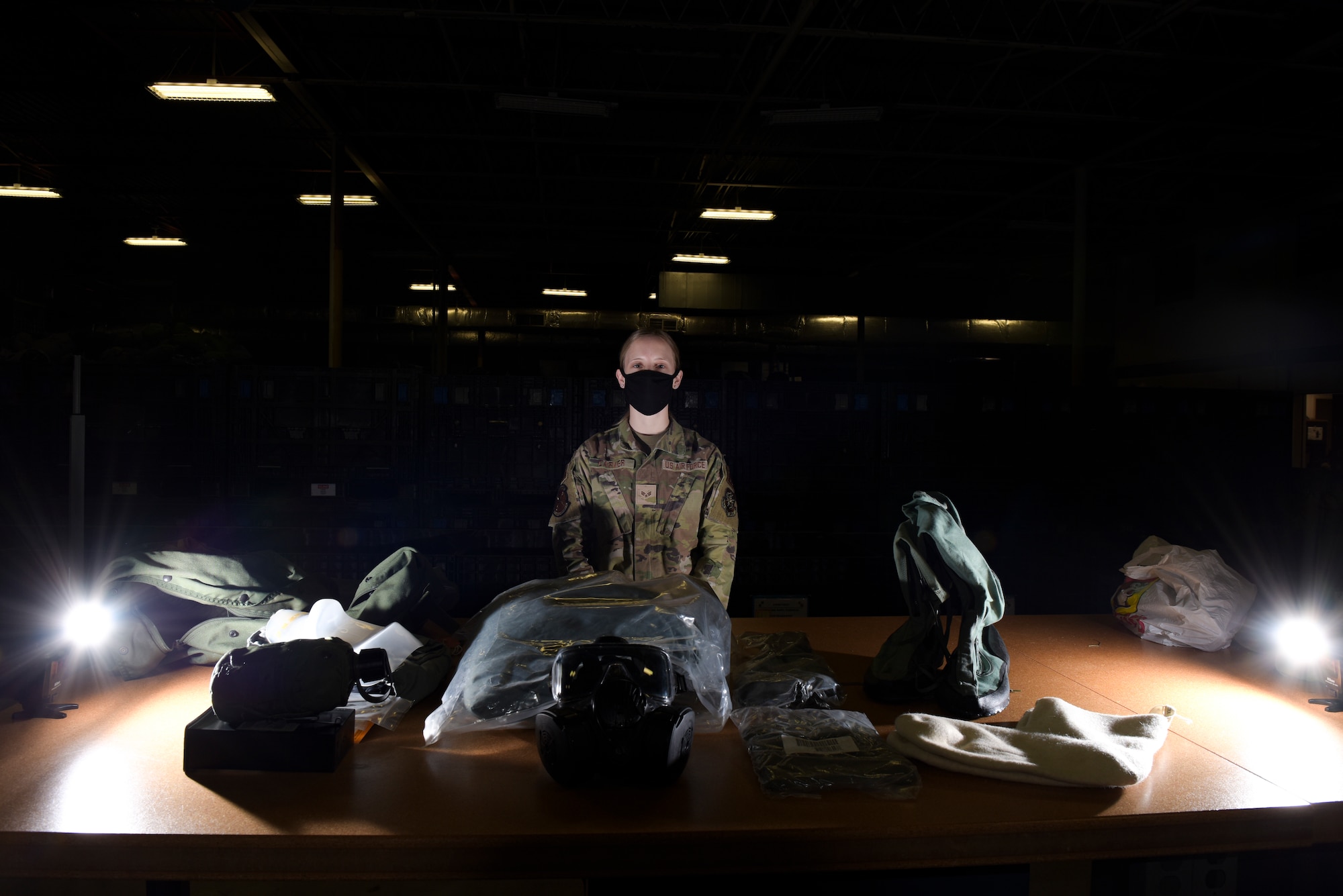 U.S. Air Force Senior Airman Paige Carver, a 6th Logistics Readiness Squadron (LRS) Individual Protective Equipment (IPE) technician, stands by a deployment bag that is issued out to base personnel at MacDill Air Force Base, Florida, Jan. 18, 2022.