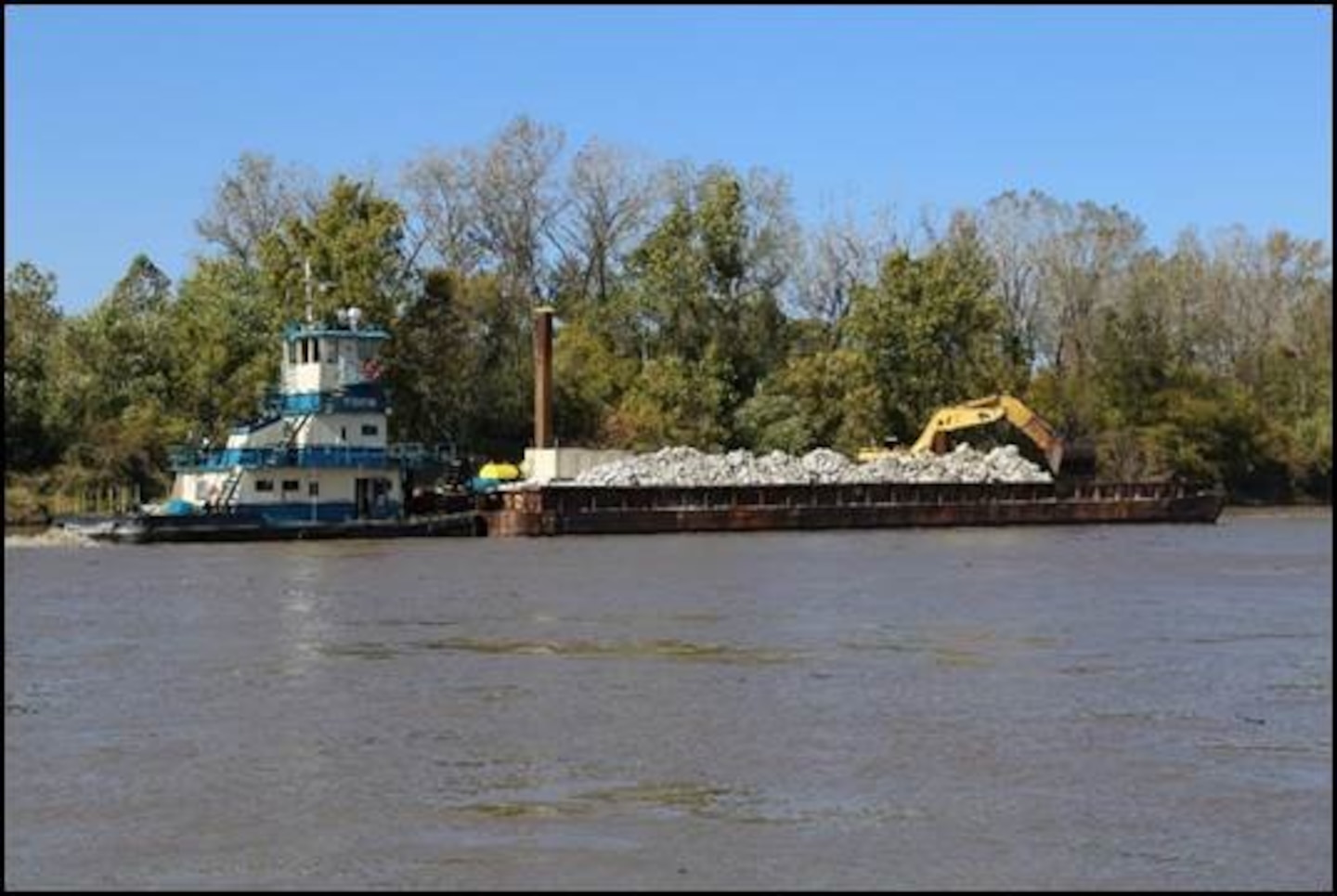Barge on the Missouri River delivers rock to stabilization areas along the river.