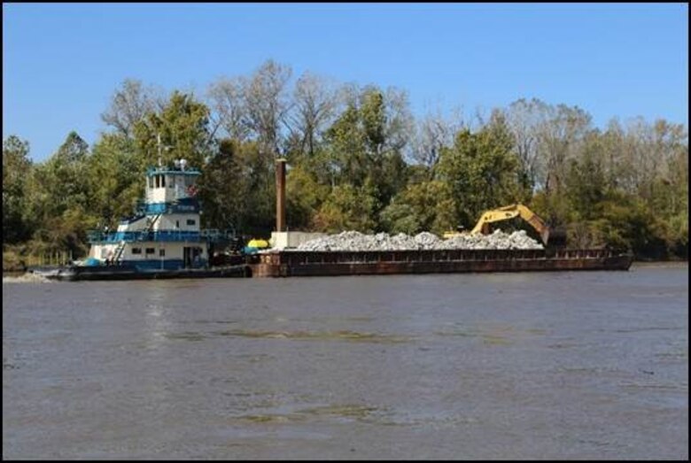 Barge on the Missouri River delivers rock to stabilization areas along the river.
