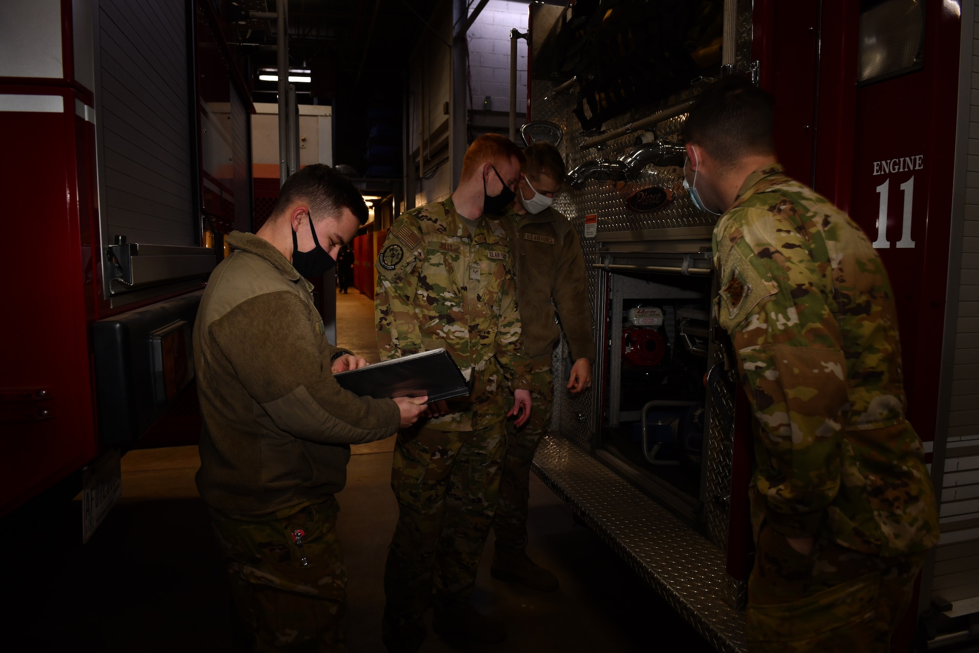 Airmen from the 97th Civil Engineer Squadron Fire and Emergency Services Flight, perform an apparatus check at Altus Air Force Base, Oklahoma, Jan. 17, 2022. The Airmen perform routine checks on the apparatus, or fire truck, to ensure that the equipment is functional and ready for any emergency. (U.S. Air Force photo by Airman 1st Class Miyah Gray)