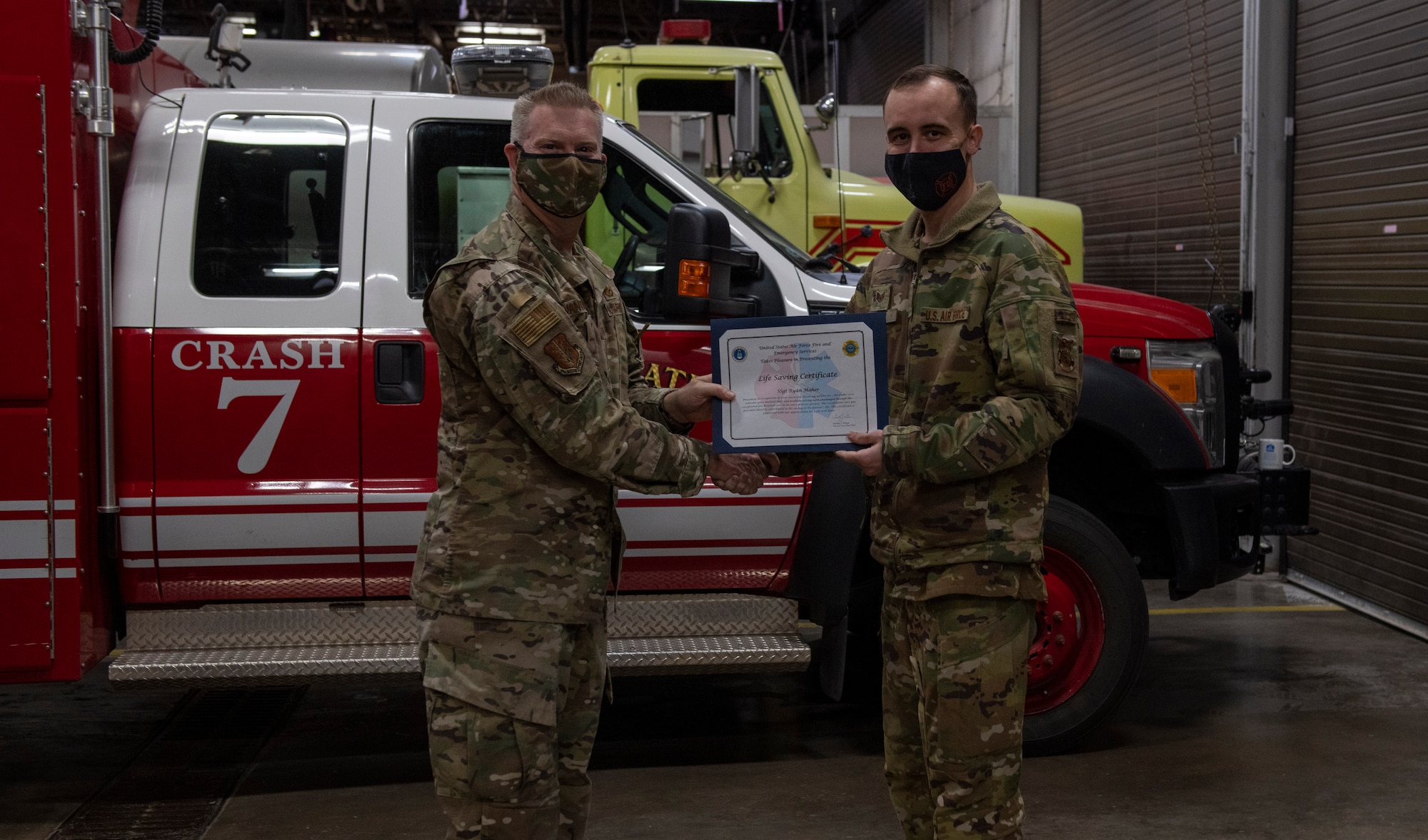 U.S. Air Force Col. David Vanderburg, 97th Mission Support Group commander, poses with Staff Sgt. Ryan Mayher, 97th Civil Engineer Squadron Fire and Emergency Services firefighter, at Altus Air Force Base, Jan. 13, 2022. Mayher was honored for his efforts in saving the life of a 78-year-old individual. (U.S. Air Force photo by Airman 1st Class Miyah Gray)