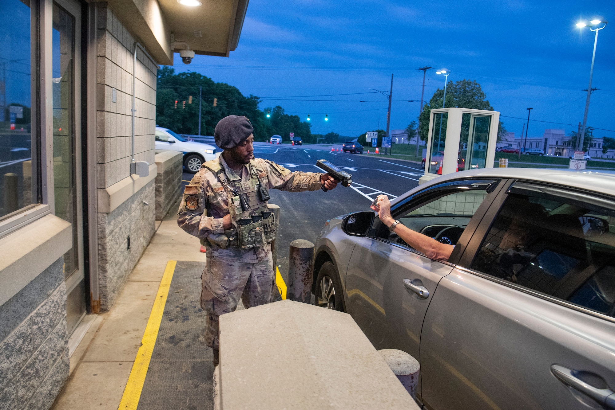 Photo of a defender checking ID's at the gate