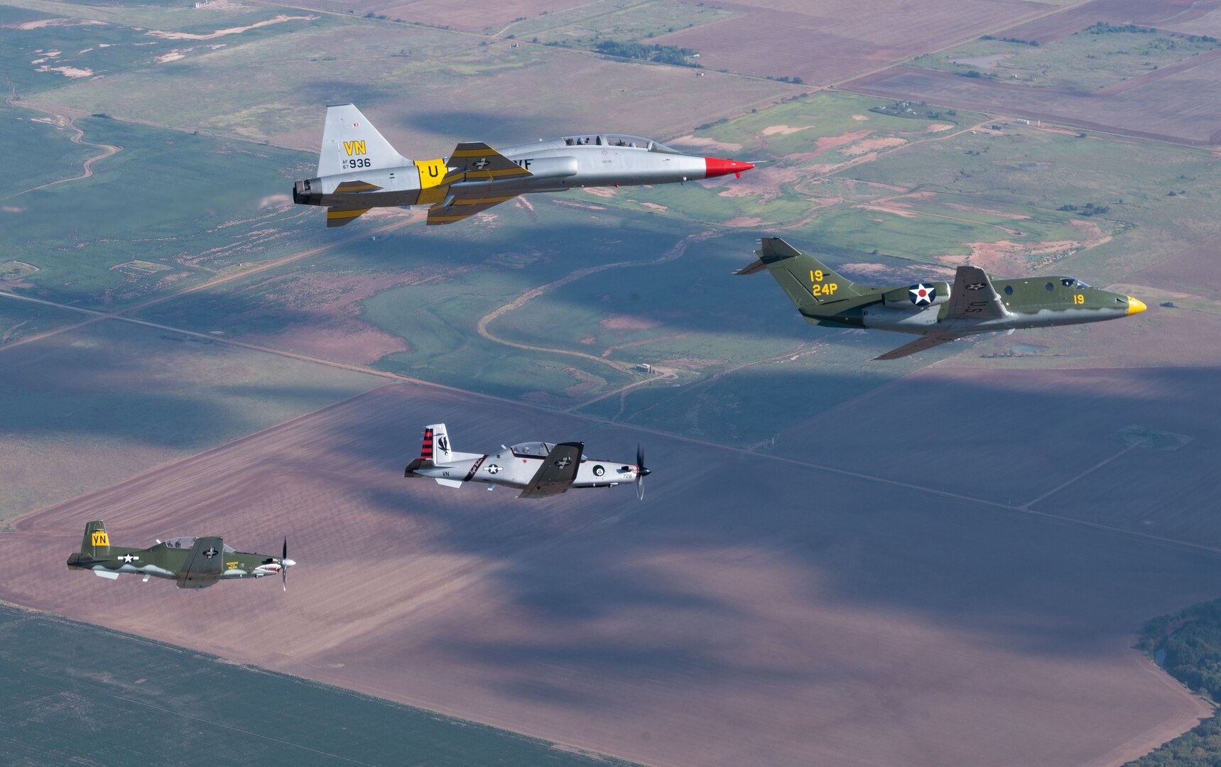 Heritage Aircraft from Vance Air Force Base fly in a dessimilar formation on the way to the Woodring Regional Airport where Vance members and the Enid community will celebrate their 80 year partnership