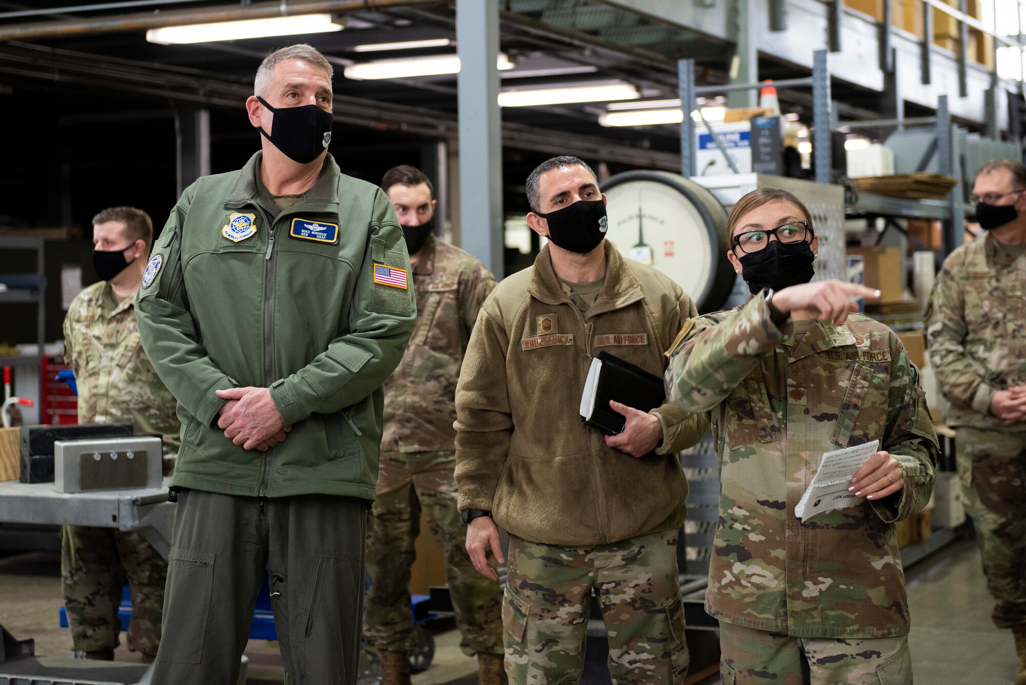 Maj Tia Ahlf, 92nd Logistics Readiness Squadron commander (right), walks Gen. Mike Minihan, Air Mobility Command commander (left), and Chief Master Sgt. Brian Kruzelnick, AMC command chief (middle), through a logistics warehouse at Fairchild Air Force Base, Washington, Jan. 6, 2022. Team Fairchild viewed this visit as an opportunity to showcase their successes and candidly explain the challenges they’ve faced. (U.S. Air Force photo by Amn Jenna A. Bond)
