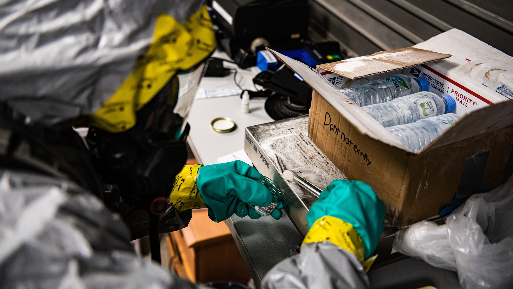 Airmen collect samples from a suspicious package.