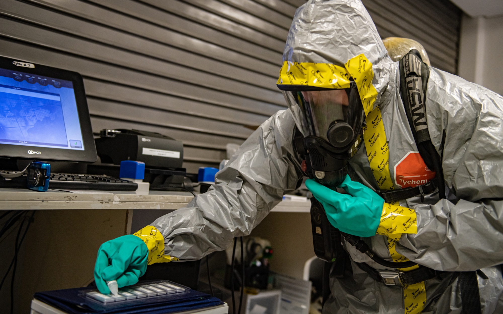 Airman tests samples from a suspicious package.