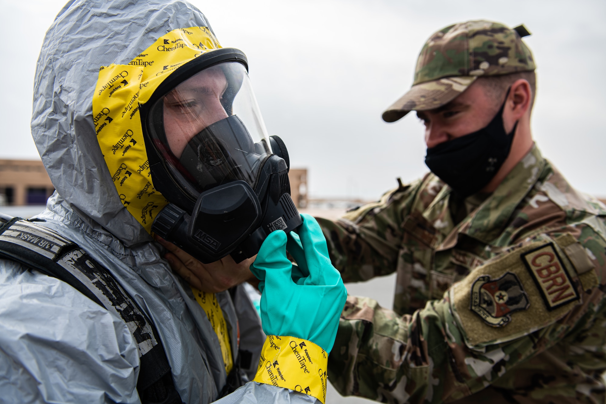 Airmen put on personal protective gear.