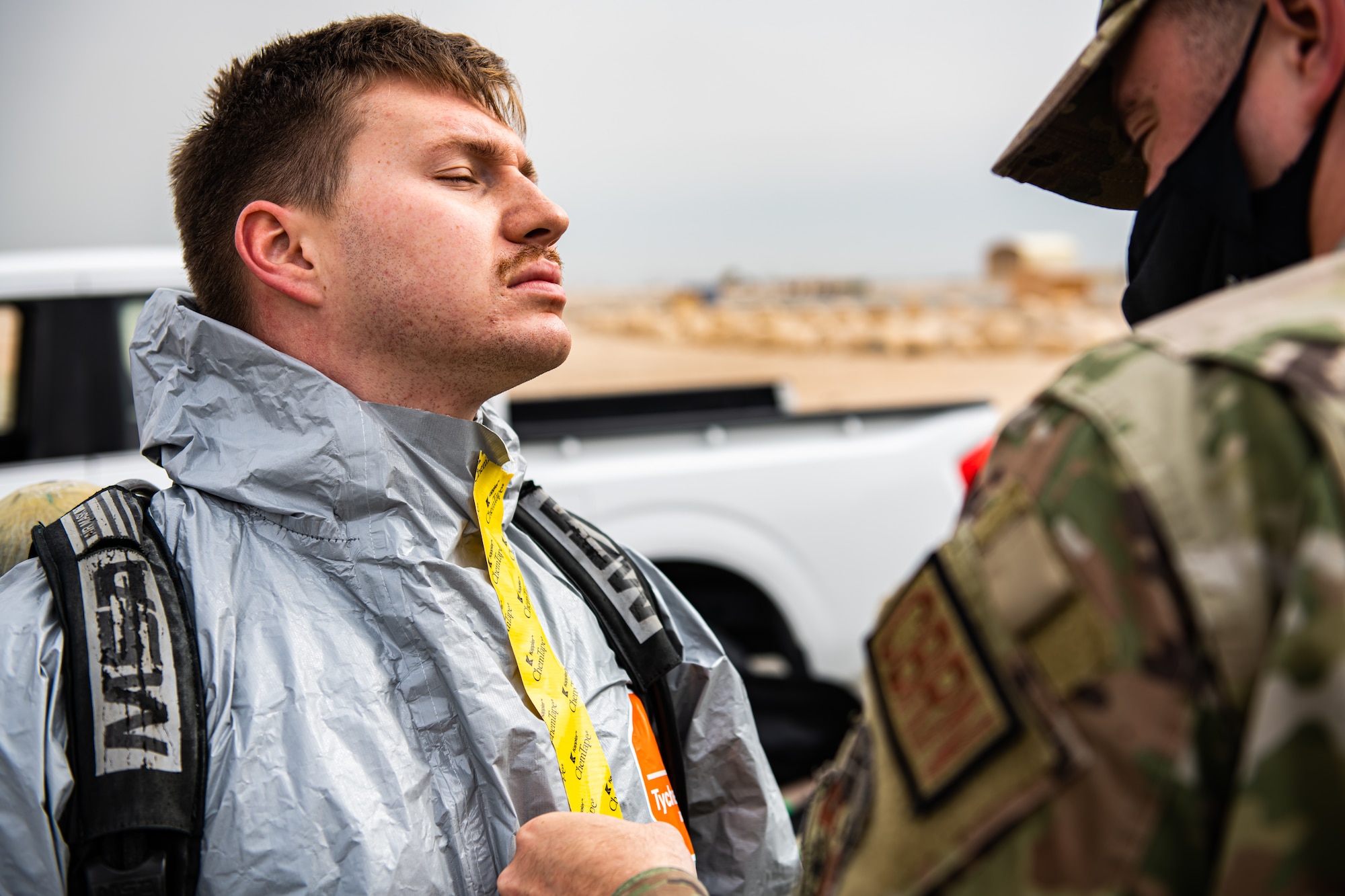 Airman puts on personal protective gear.