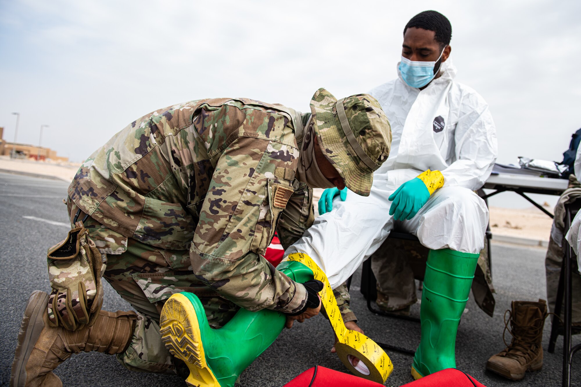 Airmen put on personal protective equipment.