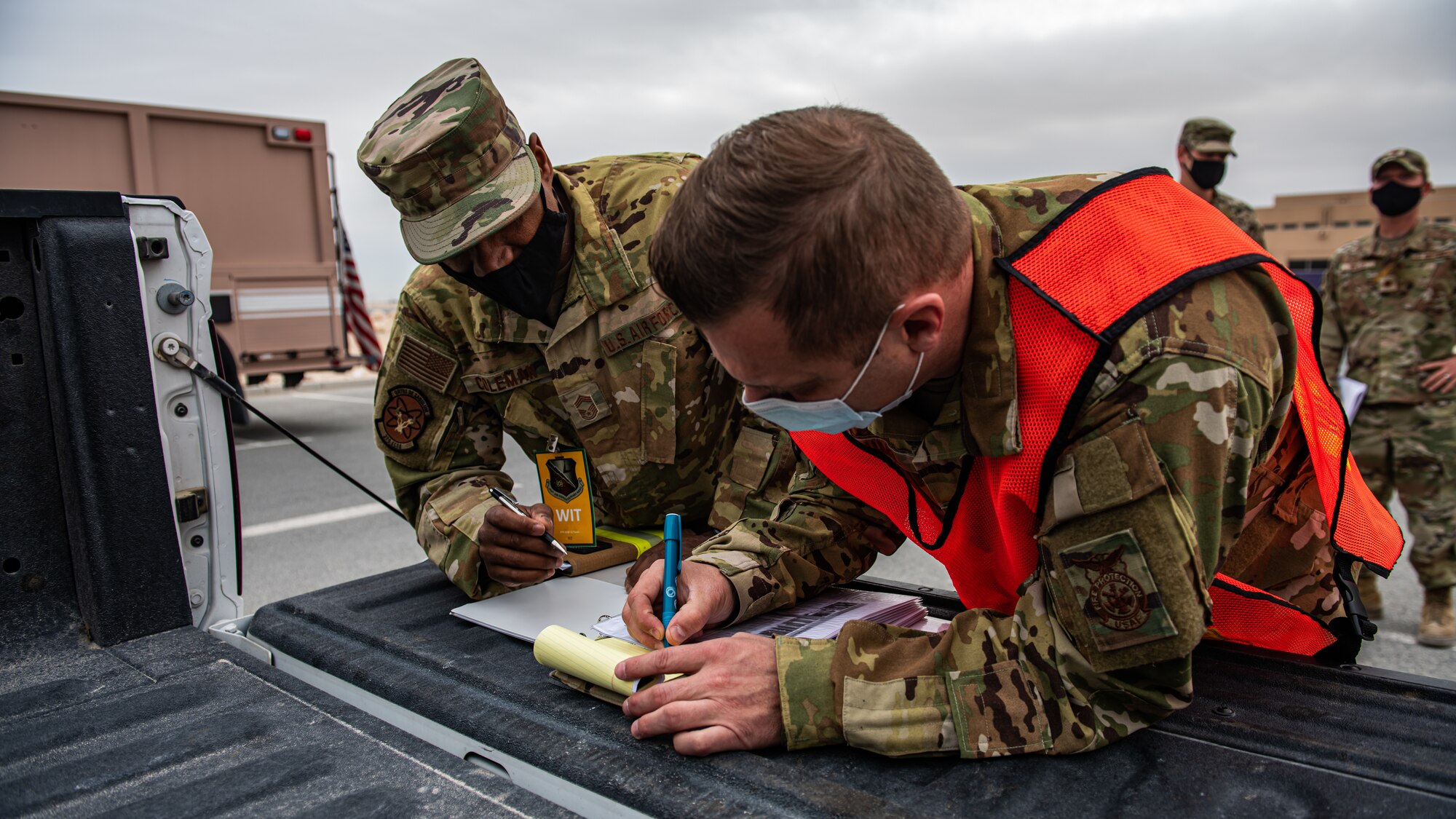 Airmen write down notes.