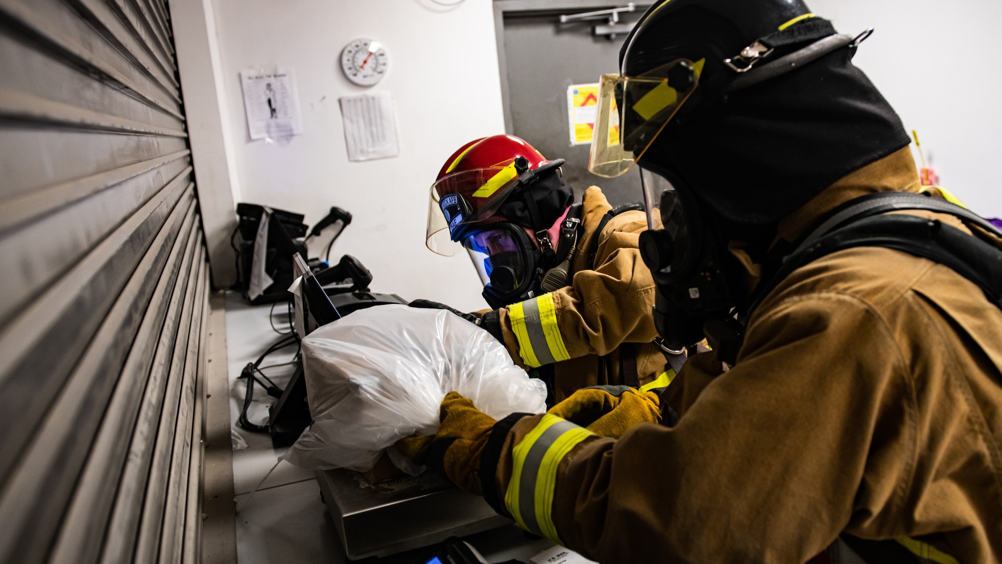 Firefighters inspect suspicious package.