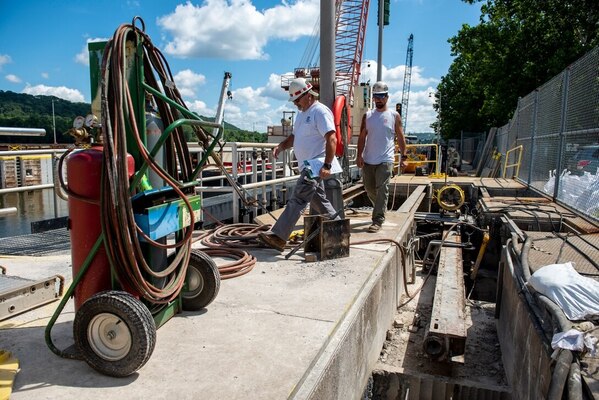 Crewmembers walk across a beam over a hydraulic cylinder pit at the Montgomery Locks and Dam on the Ohio River in Beaver County, Pennsylvania (U.S. Army photo by Michel Sauret).