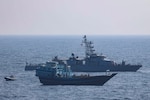 GULF OF OMAN (Jan. 18, 2022) U.S. service members conduct a boarding on a stateless fishing vessel transiting international waters the Gulf of Oman as a rigid-hull inflatable boat and patrol coastal ship USS Chinook (PC 9) sail nearby, Jan. 18. (U.S. Navy photo)