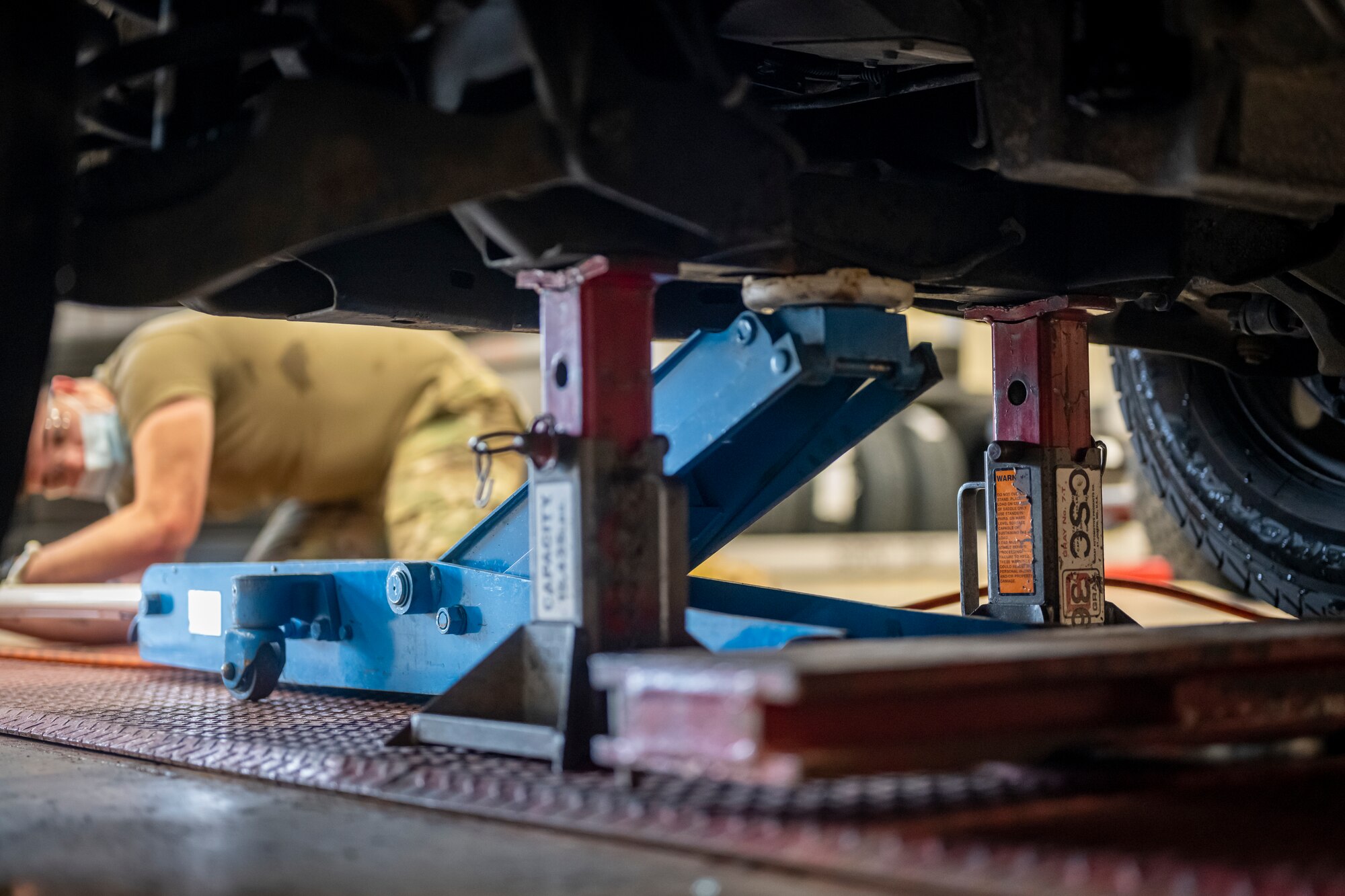 Photo of two locking jack securing a truck off the ground.