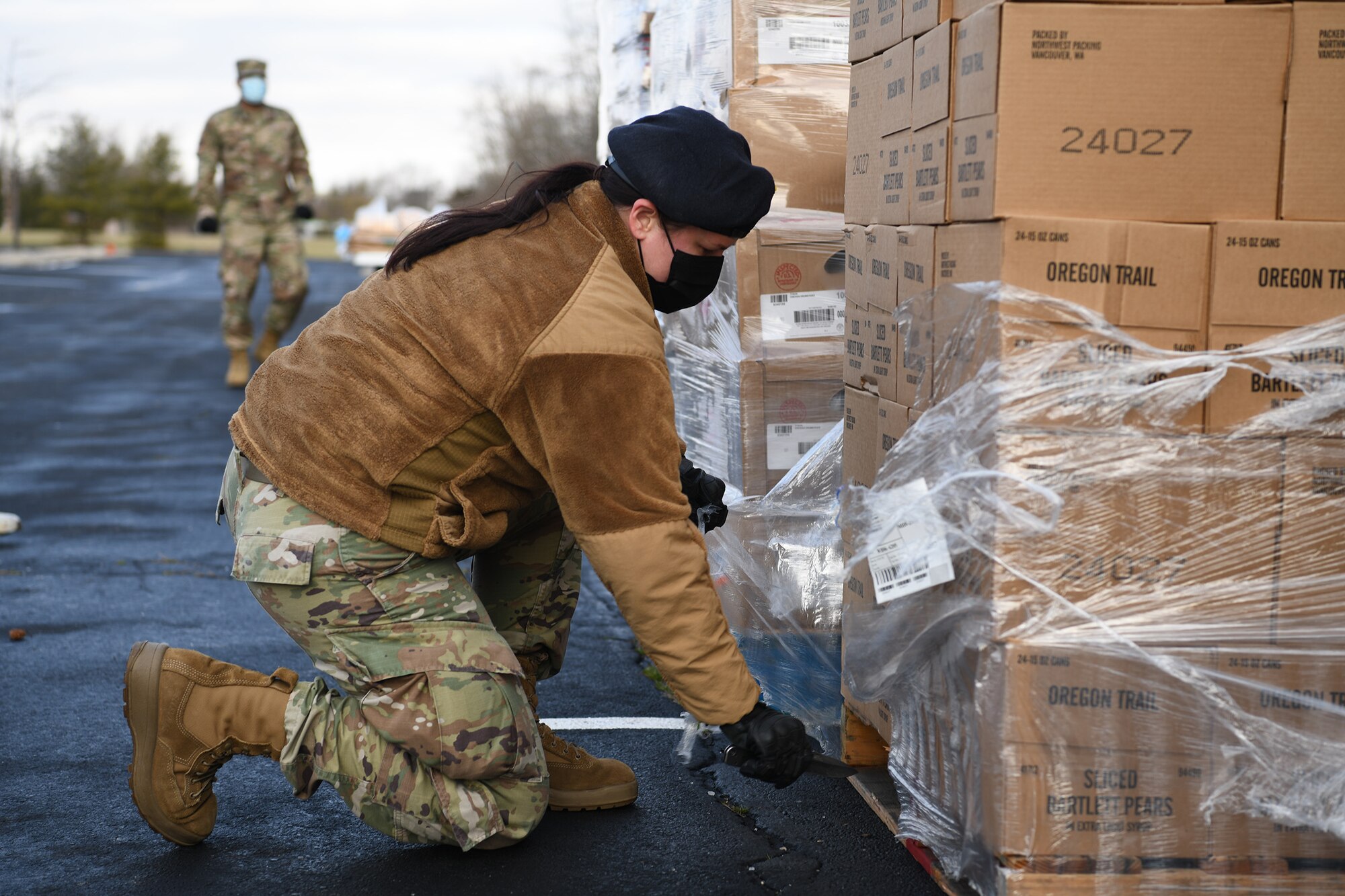 Staff Sgt. Paula Newman, 445th Security Forces Squadron/445th Airlift Wing Development and Training Flight program manager, helps unload a pallet of donated food items during a mobile food bank delivery held at Phillips Temple Church, Trotwood, Ohio Jan. 19, 2022. Fifteen volunteers from the 655th ISR Wing and 445th Airlift Wing collected, sorted, organized and prepped food that included fresh fruit, vegetables, chicken and baked goods that was given to 86 families in need within the Trotwood area.