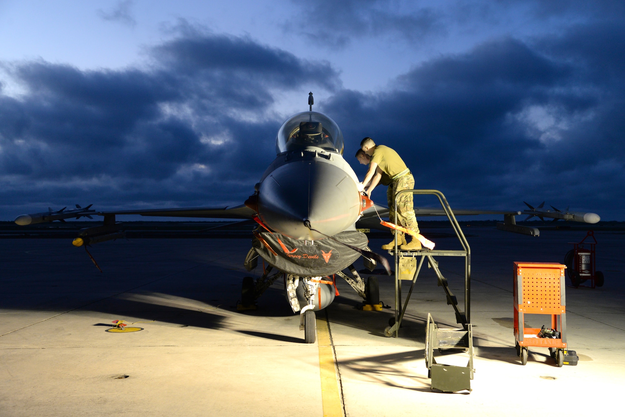 From right, U.S. Air Force Staff Sgts. Nicholas McLaughlin and Robert Burkett, electrical and bioenvironmental technicians with the 177th Fighter Wing of the New Jersey Air National Guard, change a bioenvironmental control system component in an F-16C Fighting Falcon on the flight line at Boca Chica Naval Air Station, Fla. Jan. 11, 2022.