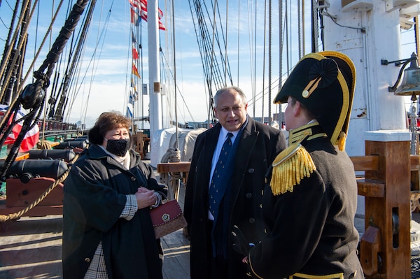 Secretary of the Navy Carlos Del Toro, center, speaks to Cmdr. Billie J. Farrell, commanding officer of USS Constitution, at the ship's change of command ceremony.