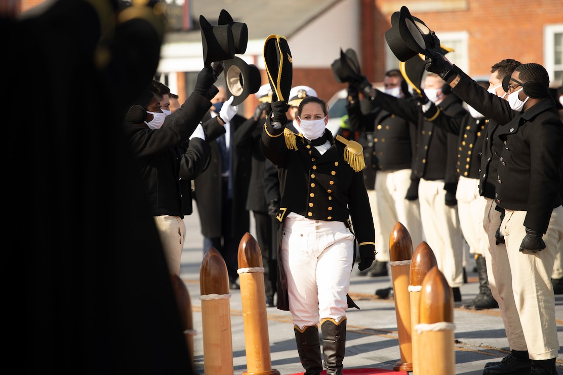 Cmdr. Billie J. Farrell renders a salute as she passes through Honor Side Boys during USS Constitution’s Change of Command ceremony.