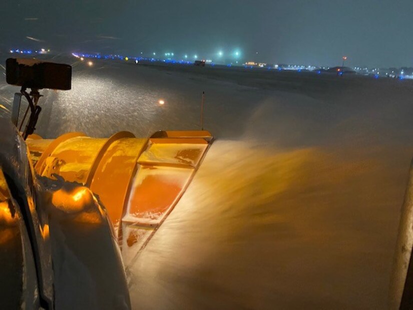 Large snow equipment removes snow from the flight line at Joint Base Langley-Eustis, Jan. 21, 2022.