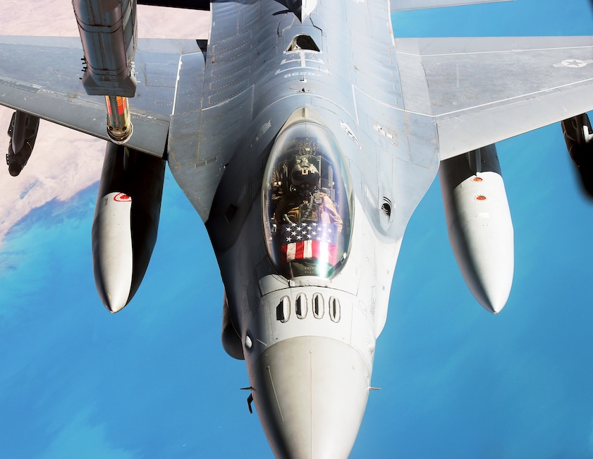 The Stars and Stripes of the American flag are on display in the cockpit of an F-16 Fighting Falcon as the pilot prepares to refueling from a KC-10 Extender from Al Dhafra Air Base, United Arab Emirates, Dec. 25, 2021. The mission, on Christmas Day, was part of the U.S. Air Force’s continued support of partners and allies in the Central Command Area of Responsibility. (U.S. Air Force photo by Master Sgt. Dan Heaton)