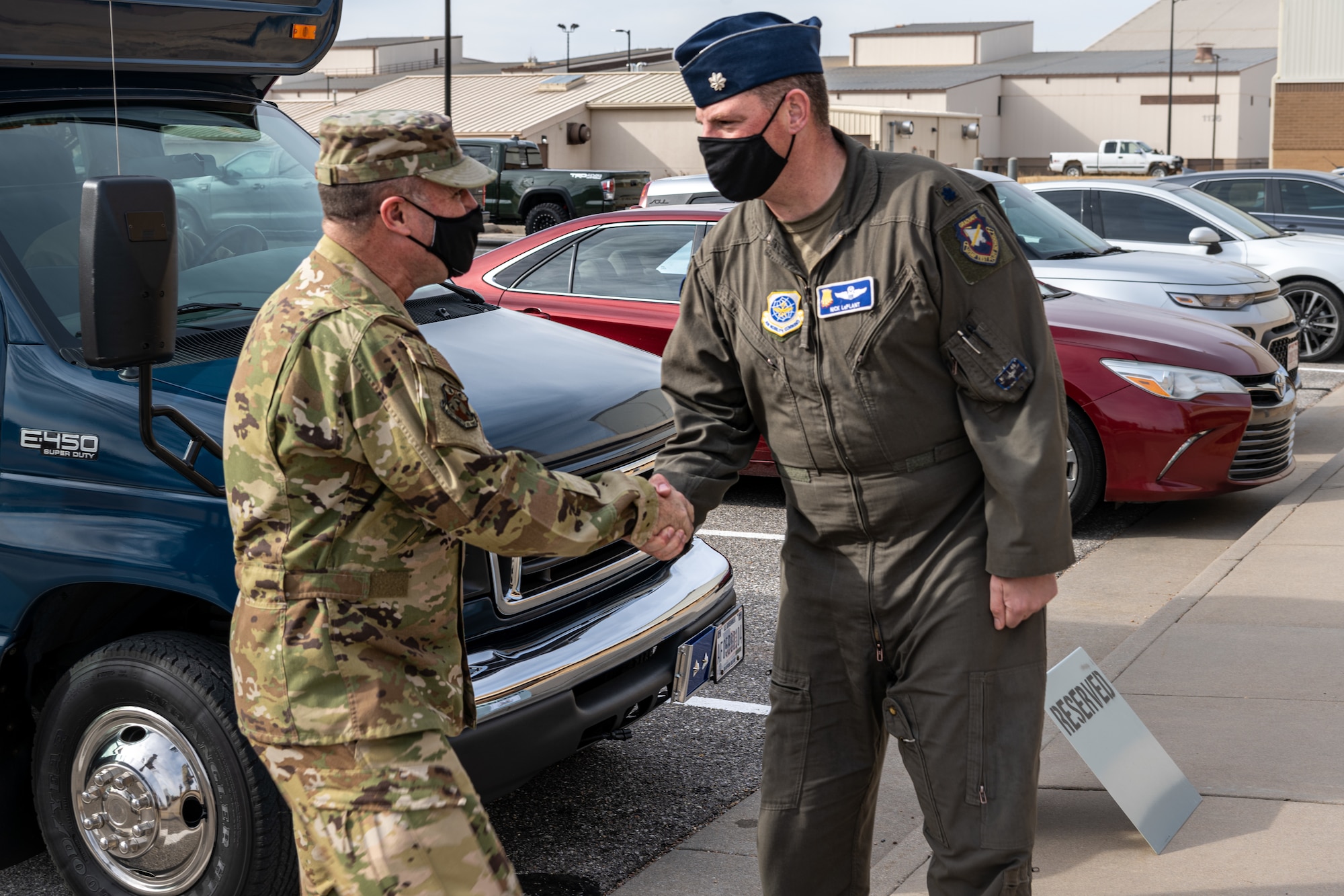 Maj. Gen. Thad Bibb, 18th Air Force commander, is greeted by Lt. Col. Nicholas LaPlant, 22nd Operations Group deputy commander, at the building where the KC-46A Pegasus flight simulator is housed Jan. 18, 2022, at McConnell Air Force Base, Kansas.
