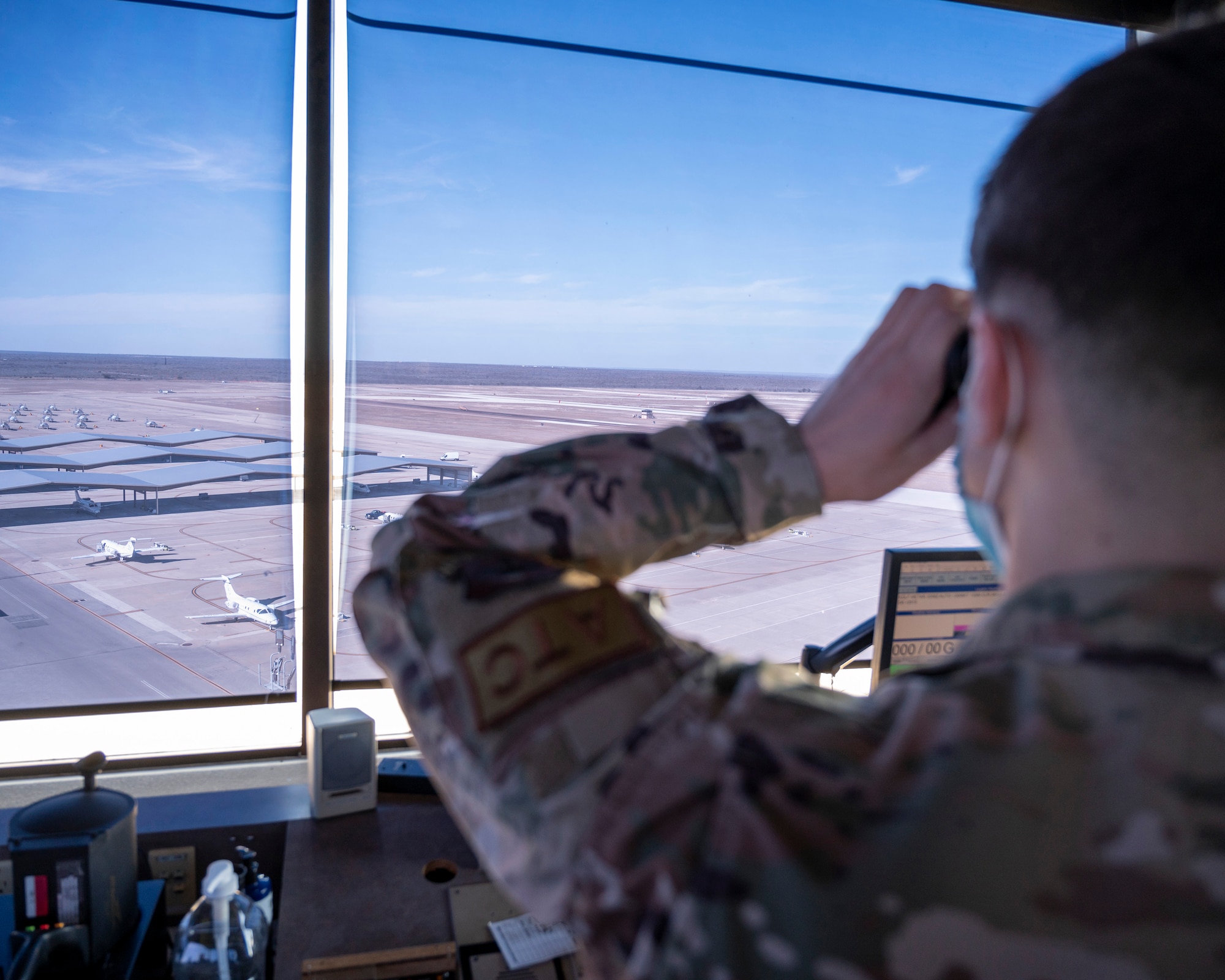 Senior Airman Gabriel Gilley watches from the Air Traffic Control Tower on January 18, 2022 as a T-38 approaches the runway at Laughlin Air Force Base, Texas. Air Traffic Controllers play a critical part in the mission of getting pilots airborne and keeping them safe in the skies. (U.S. Air Force photo by Senior Airman Nicholas Larsen)