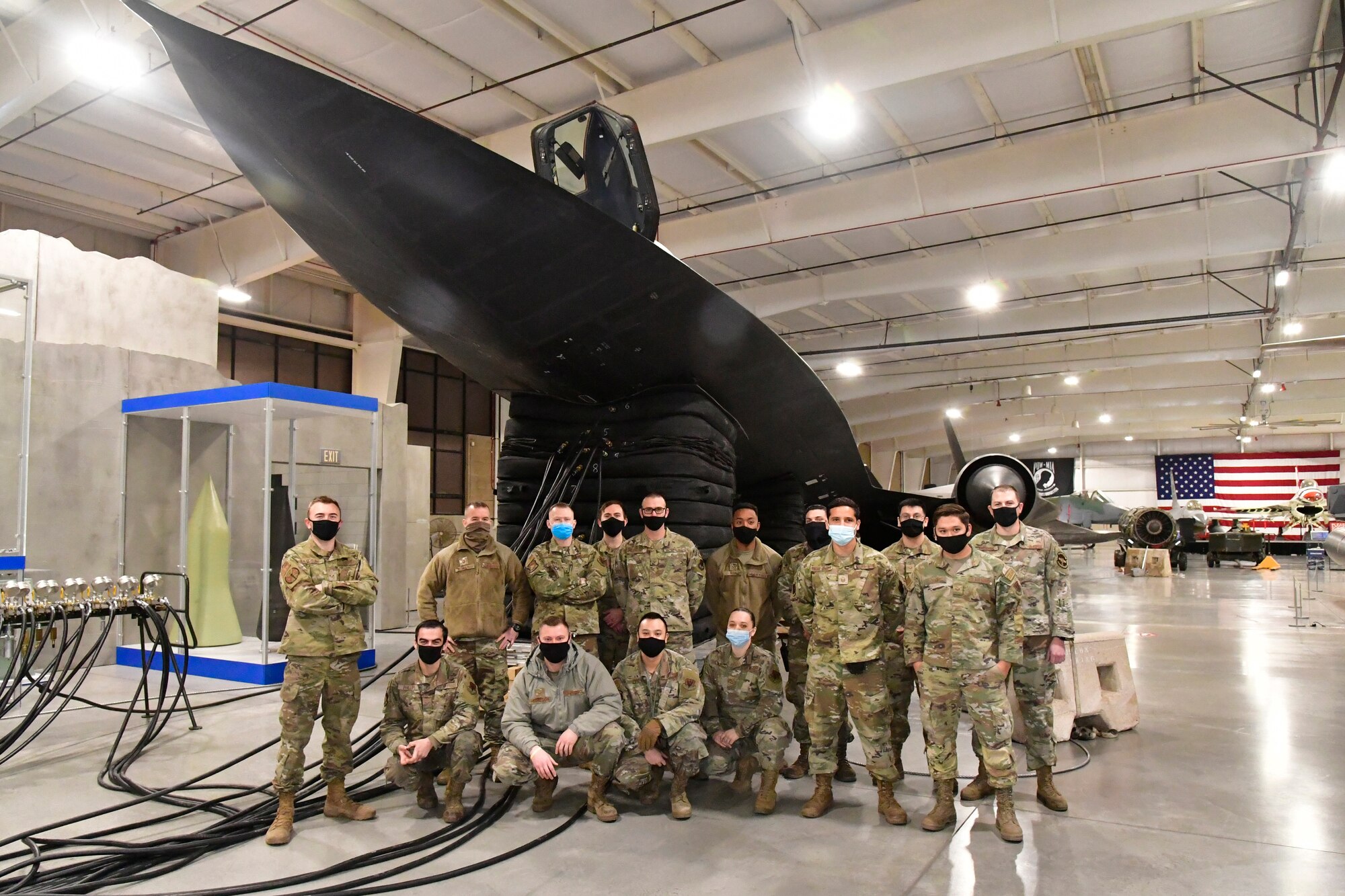 388th Maintenance Squadron maintainers gather for a photo after lifting the nose of an SR-71 static display Jan. 12, 2022, Hill Air Force Base Utah. The SR-71 “Blackbird” is on display at the Hill Aerospace Museum and was lifted by staff and 388th maintainers in order to give the jet a take-off profile appearance while allowing museum guests a closer look under and around the aircraft. (U.S. Air Force photo by Todd Cromar)