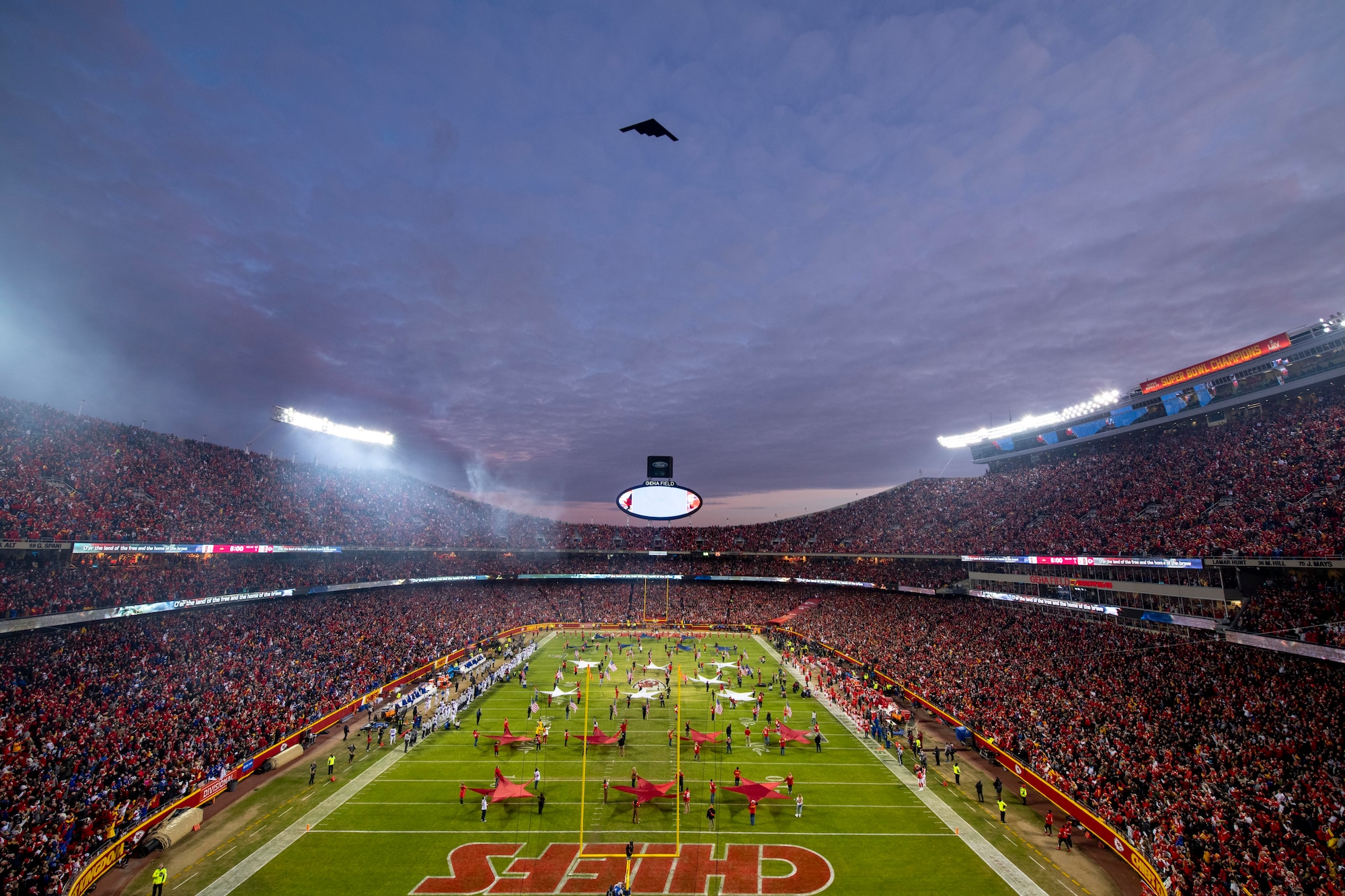 A B-2 Spirit from Whiteman Air Force Base, Missouri, performs a flyover before the AFC Divisional Playoff game at Arrowhead Stadium, Kansas City, Missouri, Jan. 23, 2022. B-2 crews perform flyovers as part of regularly scheduled training flights and to support community functions and government events. (U.S. Air Force Photo by Tech. Sgt. Dylan Nuckolls)
