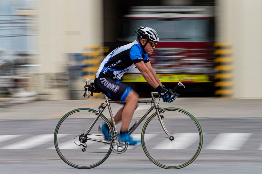 A bicyclist travels on a street.