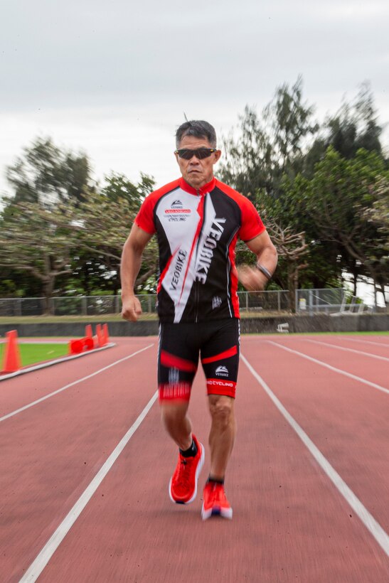 A man runs on a track.
