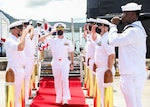 NAVAL BASE GUAM (Sept. 3, 2021) Cmdr. Sean Welch, from Colonie, New York, passes through side boys during a change of command ceremony for the Los Angeles-class fast-attack submarine USS Oklahoma City (SSN 723), Sept. 3. Welch relieved Cmdr. Steven Lawrence, from Bridgeport, Pennsylvania, as Oklahoma City’s commanding officer during a ceremony held aboard the submarine. (U.S. Navy photo by Mass Communication Specialist 1st Class Jordyn Diomede)