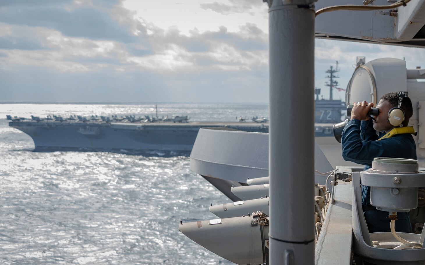 220122-N-EE352-1803 PHILIPPINE SEA (Jan. 22, 2022) Seaman, Ethan Burney, a native of Lakewood, Ohio, stands watch during flight operations aboard Nimitz-class aircraft carrier USS Carl Vinson (CVN 70), Jan. 22, 2022. Operating as part of U.S. Pacific Fleet, Vinson is conducting training to preserve and protect a free and open Indo-Pacific region. (U.S. Navy photo by Mass Communication Specialist Seaman Leon Vonguyen)