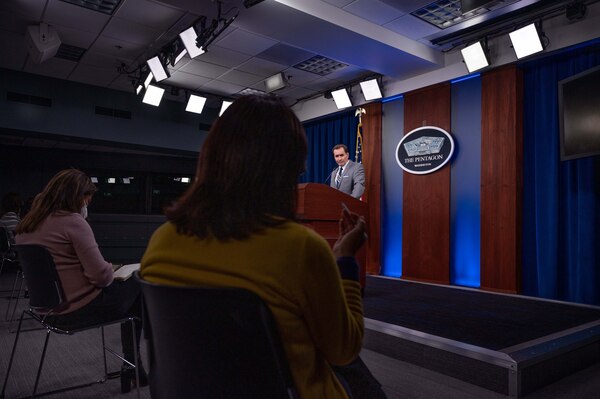 A man stands at a lectern during a news conference.