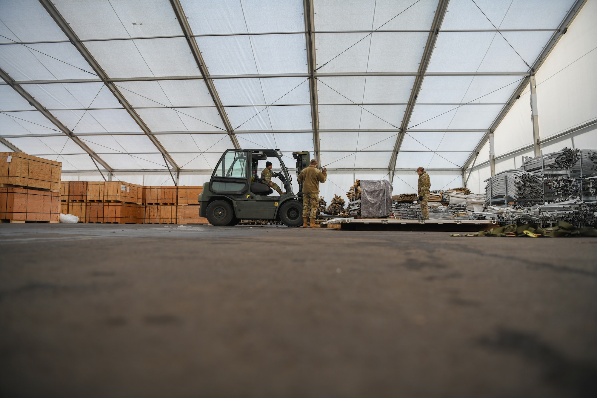 Airmen from the 435th Air Expeditionary Wing load a pallet with tent skins and liners for U.S. and allied service members at Nigerien Air Base 101 and 201 at Ramstein Air Base, Germany, Jan 21, 2022. During a flood, tents were damaged at Nigerien Air Base 101 and 201, which required approximately 15 new replacements. Ensuring Airmen are mission ready guarantee combatant commanders the ability to forward project power across air, space and cyber domains, and defend U.S. interests. (U.S. Air Force photo by Senior Airman Ericka A. Woolever)