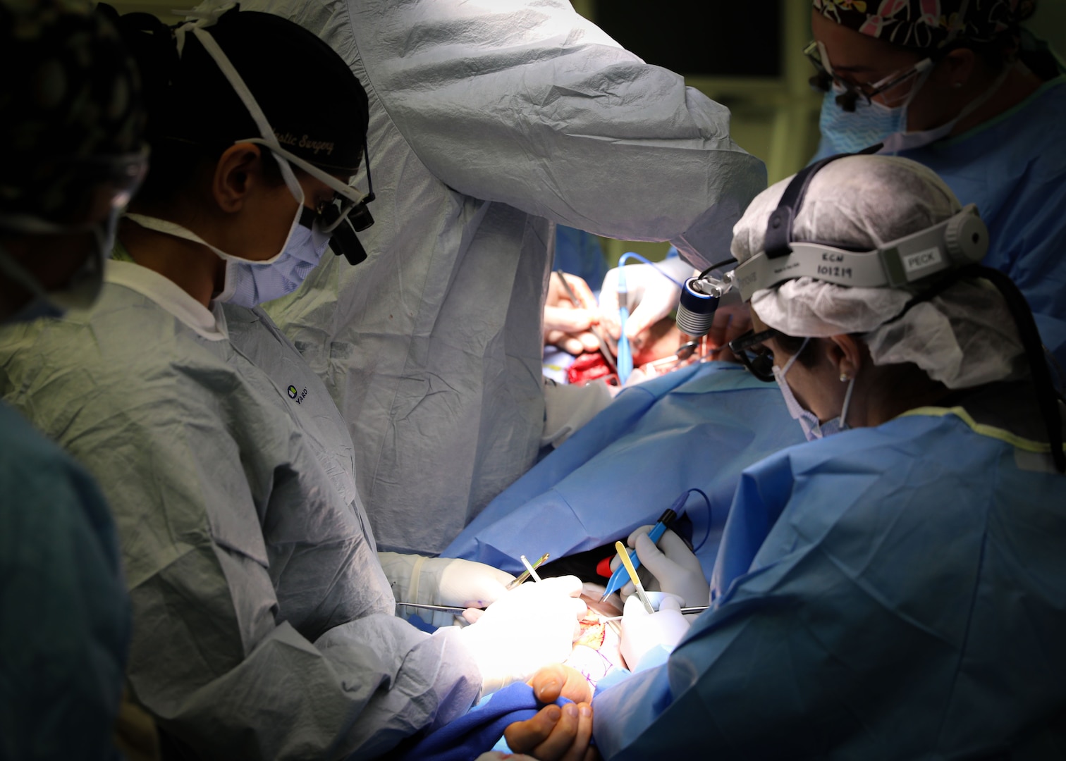 (From left) U.S. Army Lt. Col. Shimul Patel, chief, Plastic Surgery Services, Landstuhl Regional Medical Center, and U.S. Army Lt. Col. Jessica Peck, chief, Ear, Nose and Throat Clinic, LRMC, operate on a cancer patient during the first microvascular reconstruction and anastomosis procedure ever performed at LRMC, Dec. 3. The first-of-its-kind procedure at LRMC expands services and capabilities at the only Level II Trauma Center outside the United States and principal evacuation and treatment center for all injured U.S. Service Members, civilians and Coalition Forces serving across Europe, Africa and the Middle East.