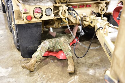 Mechanics from Foxtrot Company, 132nd Forward Support Company, attached to 1st Battalion, 120th Field Artillery Regiment, Wisconsin National Guard, prepare vehicles for extreme cold weather training during exercise Northern Strike 22-1/"Winter Strike," Jan. 22, 2022. The exercise is bringing together hundreds of military personnel from several states and partner forces Jan. 21-30 at Camp Grayling Joint Maneuver Training Center and Alpena Combat Readiness Training Center in northern Michigan, which comprise the National All-Domain Warfighting Center.