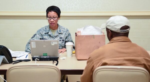 A paralegal helps a man file his taxes.