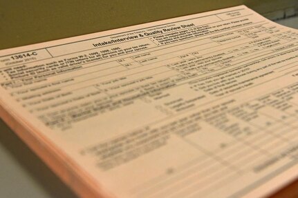 An intake/interview and quality review sheet for tax filing is shown.