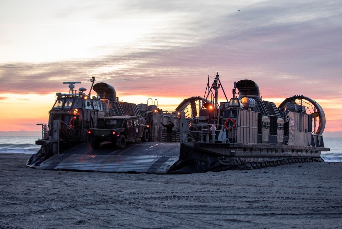 U.S. Marines assigned to the 22nd Marine Expeditionary Unit (MEU), load vehicles onto a landing craft, air cushion during an on loading of personnel and gear aboard Camp Lejeune, Jan. 15, 2022. The Kearsarge Amphibious Ready Group (ARG) and 22nd MEU are underway conducting Composite Training Unit Exercise (COMPTUEX). COMPTUEX is the final pre-deployment exercise that certifies the Kearsarge ARG and 22nd MEU’s ability to conduct military operations through joint planning, and execute challenging and realistic scenarios. (U.S. Marine Corps photo by Sgt. Mason Roy)