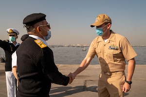 220125-N-N0146-1003 KARACHI, Pakistan (Jan. 25, 2022) Lt. Cmdr. Martin Dineen, commanding officer of USS Whirlwind (PC 11), greets a Pakistani officer after arriving in Karachi, Pakistan, for a scheduled port visit Jan. 25. Whirlwind is currently operating in the Middle East region to help ensure maritime security and stability.