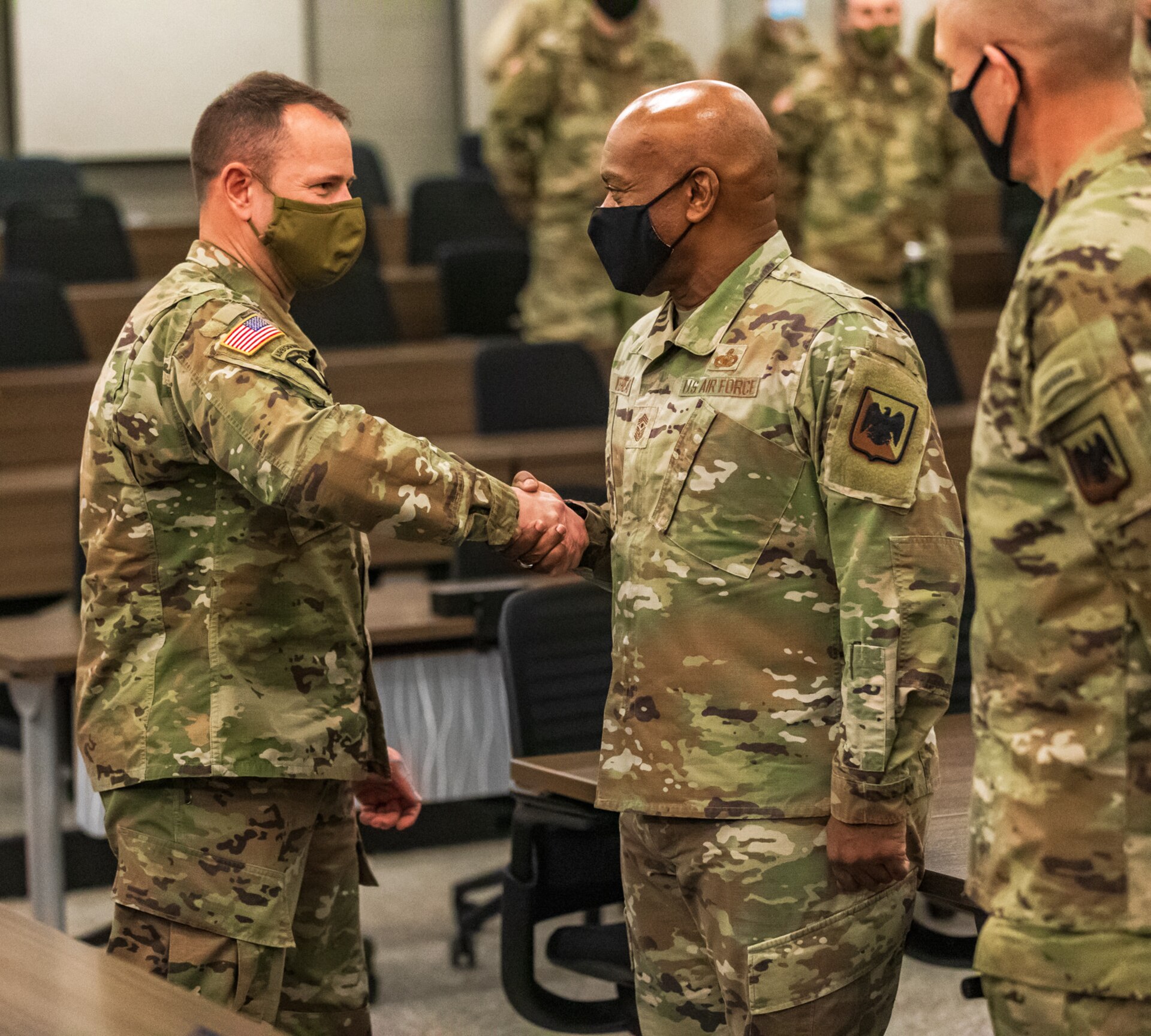 Kentucky National Guard leadership welcomed National Guard Bureau’s senior leaders on Jan. 23-24, to recognize Guard members for their efforts and thank them for supporting local communities in western Kentucky. Senior Enlisted Advisor Tony Whitehead receives a coin from Spc. Cameron Maley at the Mayfield Fairgrounds distribution site in Mayfield, Ky., Jan. 22, 2022.