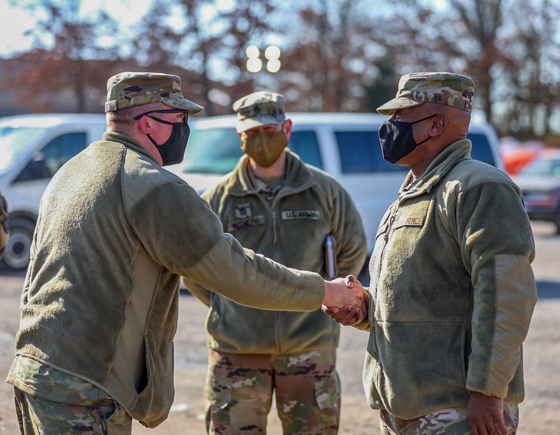 Kentucky National Guard leadership welcomed National Guard Bureau’s senior leaders on Jan. 23-24, to recognize Guard members for their efforts and thank them for supporting local communities in western Kentucky. Senior Enlisted Advisor Tony Whitehead receives a coin from Spc. Cameron Maley at the Mayfield Fairgrounds distribution site in Mayfield, Ky., Jan. 22, 2022.
