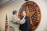 Oklahoma National Guard Brig. Gen. Thomas Mancino, the adjutant general for Oklahoma, presents Col. Thomas Mackey, former deputy United States Property and Fiscal officer, with the Legion of Merit award, at Joint Force Headquarters in Oklahoma City, Oklahoma, Jan. 22, 2022. Mackey’s career spanned 34 years and included three deployments. (Oklahoma National Guard photo by Spc. Danielle Rayon)